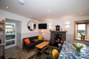 a living room with a couch and a fireplace at Oran na Cuthaig in Lochs