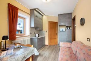 a living room with a couch and a table at Mountain Apartments Livigno in Livigno