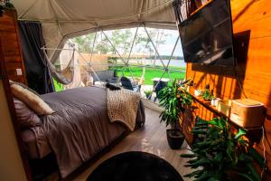 a bedroom with a bed in a tent at Island Beach Hideaways in Pomquet