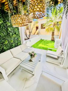 a living room with a couch and a table at Luxury villa Fanabe with private garden in Adeje