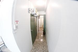 a hallway with a green door at Dickem's Transient House in Cebu City