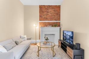 a living room with a white couch and a fireplace at Charming 2Bd in Brooklyn Heights in Brooklyn