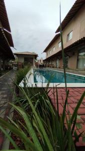 a swimming pool in front of a building at Aconchego da Jandaia in Imbassai