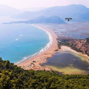 an aerial view of a beach with a sign in the air at Villa Bianca in Muğla