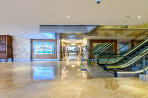 an empty lobby with escalators in a building at Windsor Marapendi Hotel in Rio de Janeiro