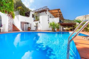 a swimming pool in front of a villa at YourHome - Villa Mia in Massa Lubrense