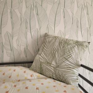 un letto con cuscino e parete di GILMORE Home - close to PARIS center a La Courneuve