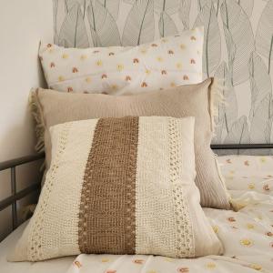 a pile of pillows on a bed with a blanket at GILMORE Home - close to PARIS center in La Courneuve