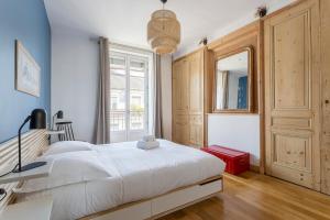a bedroom with a large white bed and a window at Hamac Suites - Le Renan - 4 people in Lyon