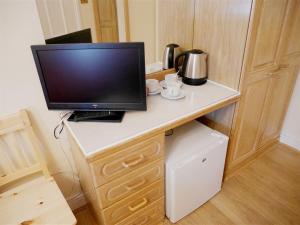 a television sitting on a desk in a room at The Gresham Hotel in London