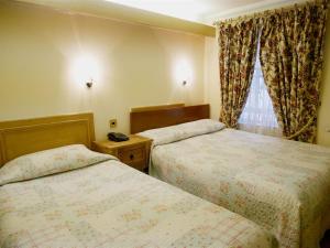 Ένα ή περισσότερα κρεβάτια σε δωμάτιο στο The Gresham Hotel