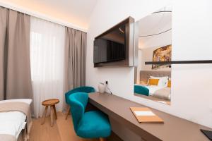 a hotel room with a desk and a bed at Hotel Sveta Ana in Donji Humac