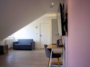 a living room with a couch and a table at The Coppice in Watford