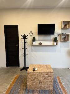 a living room with a flat screen tv on a wall at Casa Apartment Playa Tortugas in Tortuga