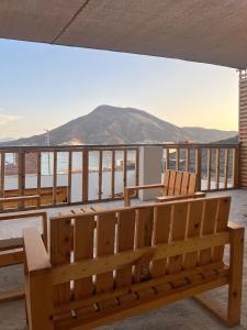 a wooden bench sitting on top of a balcony at Casa Apartment Playa Tortugas in Tortuga