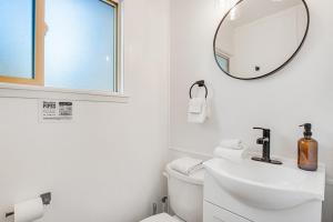 a white bathroom with a sink and a mirror at Mount Ellinor, Room 11 at Mount Walker Inn in Quilcene +19 photos