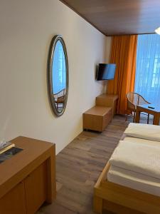 a hotel room with two beds and a mirror at Hotel Post 20 in Braunau am Inn +45 photos
