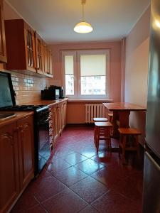 a kitchen with a table and a table and a window at Mieszkanie, Blisko Stadionu Tarczyński Arena, Blisko Hala Orbita in Wrocław