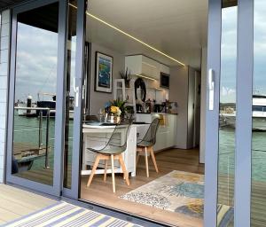a kitchen and dining room with a view of the ocean at Yarmouth Waterlodge Floating Apartment 1 in Yarmouth +16 photos