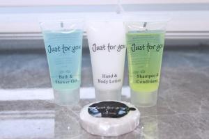 three bottles of just for you hand and body lotion at Stunning 3 bedrooms flat at Orchard House in Harlow