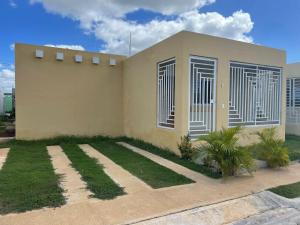 a house with grass in front of it at Ferienhaus La Romana in La Romana