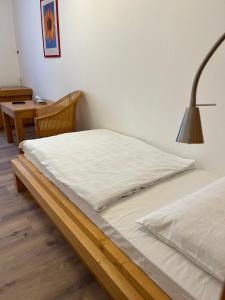 a bed with white sheets and a lamp in a room at Hotel Post 21 in Braunau am Inn +19 photos