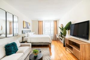 a white living room with a bed and a television at 338-3B union square Newly Reno Sleeps 3 in New York