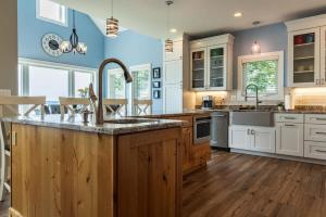 a kitchen with a sink and a counter top at Snowmobile South Manistique Lake Lakeside Luxury in Curtis +19 photos