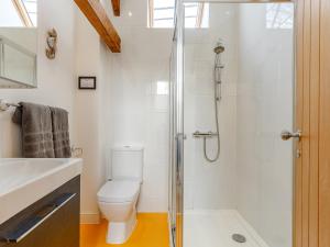 a white bathroom with a toilet and a shower at 3 Bed in Braunton 53109 in Braunton