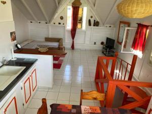 a kitchen and living room with a couch and a table at Villa Adélaïde in Grand-Bourg +36 photos