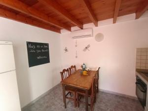 a kitchen with a table and chairs and a refrigerator at Tranquilo y Acogedor Apartamento in Órzola +13 photos