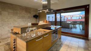 a kitchen with a counter with wine glasses on it at PENTHOUSE Synagogue - by Artemisia Luxury Apartments in Budapest