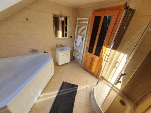 a bathroom with a tub and a sink at Orion in Borzont