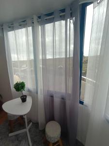 a table and a chair in front of a window at Tranquilo y Acogedor Apartamento in Órzola