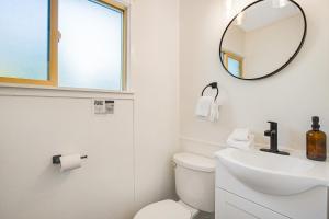 a white bathroom with a sink and a mirror at Mount Walker Suite, Room 12 at Mount Walker Inn in Quilcene +13 photos