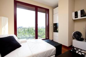 a bedroom with a white bed and a large window at One bedroom apartement with wifi at Mislata in Valencia