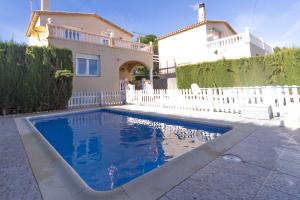 a swimming pool in front of a house at INNOUTHOME CASA CON PISCINA Av AMETLLA DE MAR in L'Ametlla de Mar