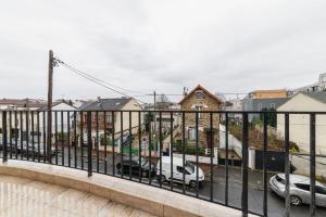 a balcony with cars parked in a city at Studio 20m2 Lumineux avec balcon - 2P in La Courneuve