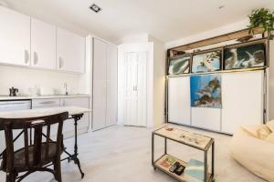 a kitchen and a living room with a table at One bedroom property with wifi at Madrid in Madrid
