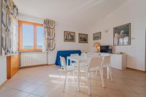 a kitchen and dining room with a table and chairs at Appartamenti Norsi in Capoliveri