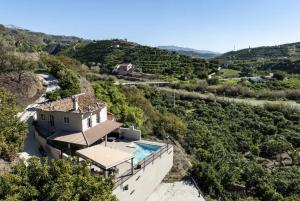 a house on a hill with a swimming pool at Villa Carrillos, 365-rentals in Benamargosa