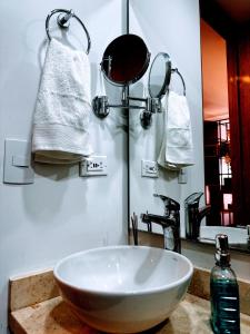 a bathroom with a bowl sink and a mirror at Loft between best business centers & restobars in Bogotá