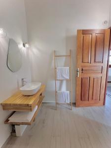 a bathroom with a sink and a mirror and a door at Résidence Antilles Bernanoune in Le Moule +51 photos