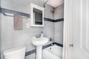 a bathroom with a sink and a toilet and a bath tub at 69-4D Trendy Lower East Side 1B BRAND NEW in New York
