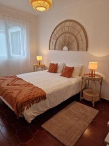 a bedroom with a large bed with two lamps at Wild Blue By SVL in Ponta Delgada