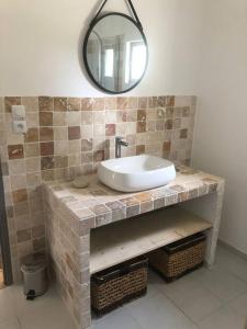 a bathroom with a sink and a mirror at Propriete d'une chambre avec piscine partagee et wifi a Saint Gilles in Saint-Gilles