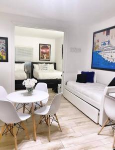 a living room with a bed and a table and chairs at BEST DEAL! 2 Bedroom Modern Beachfront by YouRent! in Miami Beach