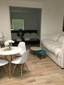 a living room with a bed and tables and chairs at BEST DEAL! 2 Bedroom Modern Beachfront by YouRent! in Miami Beach