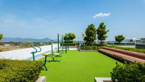 a playground with green grass next to a skate park at Апартаменты в Лагуне SkyPark c видом на гольф поле in Bang Tao Beach