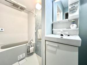 a bathroom with a sink and a shower at ANX Hostel in Tokyo